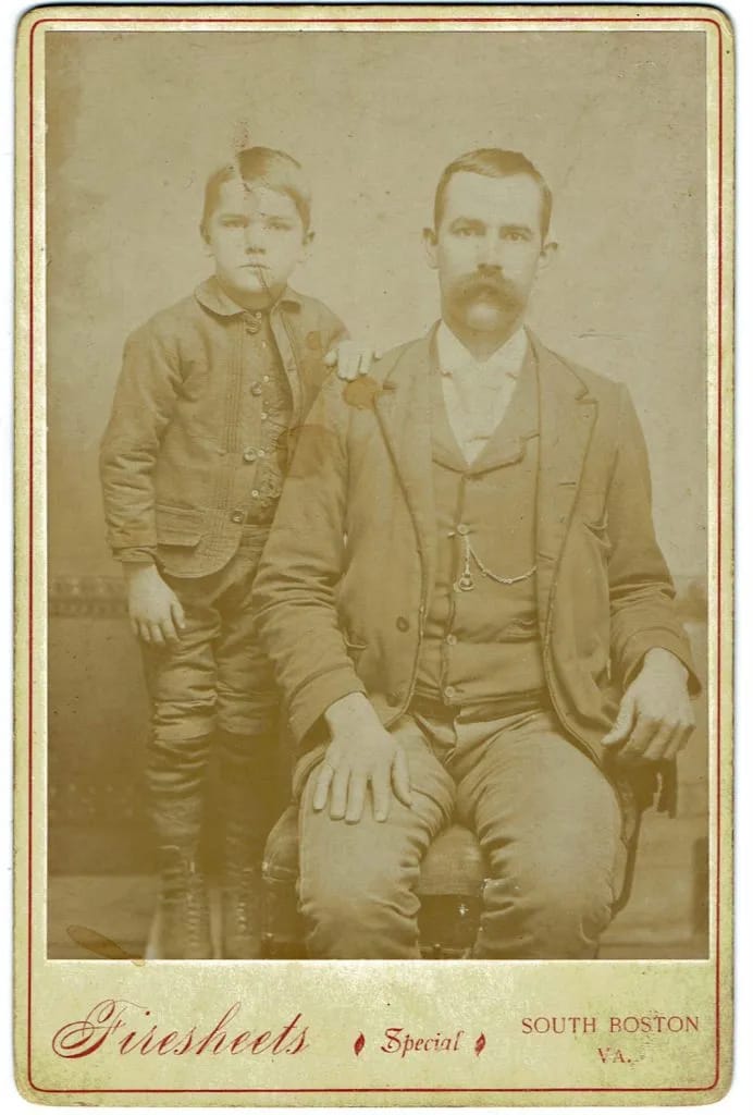 A phone photo of a torn cabinet-card portrait, before restoration