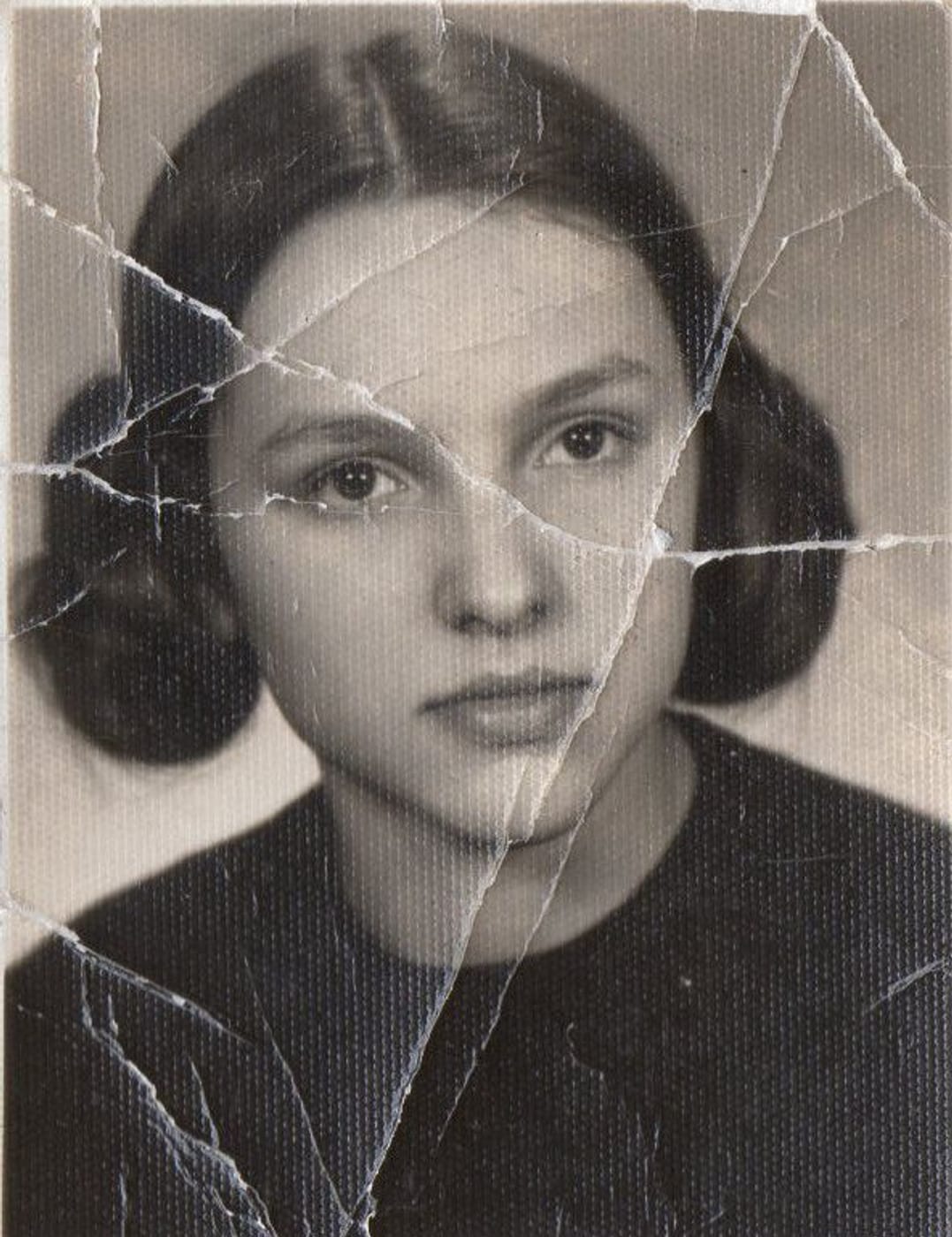 Before restoration: A web of cracks straight through her face